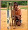 Fabi beside the cricket wickets that the children made from the jungle, using there machetes